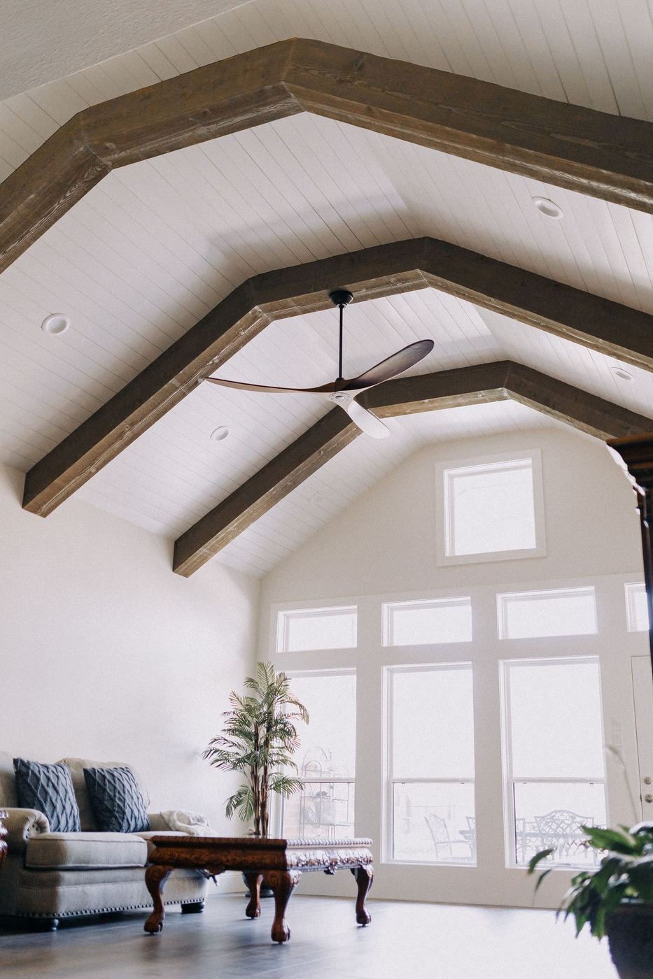 Great room renovation with vaulted ceiling and stained timber trusses