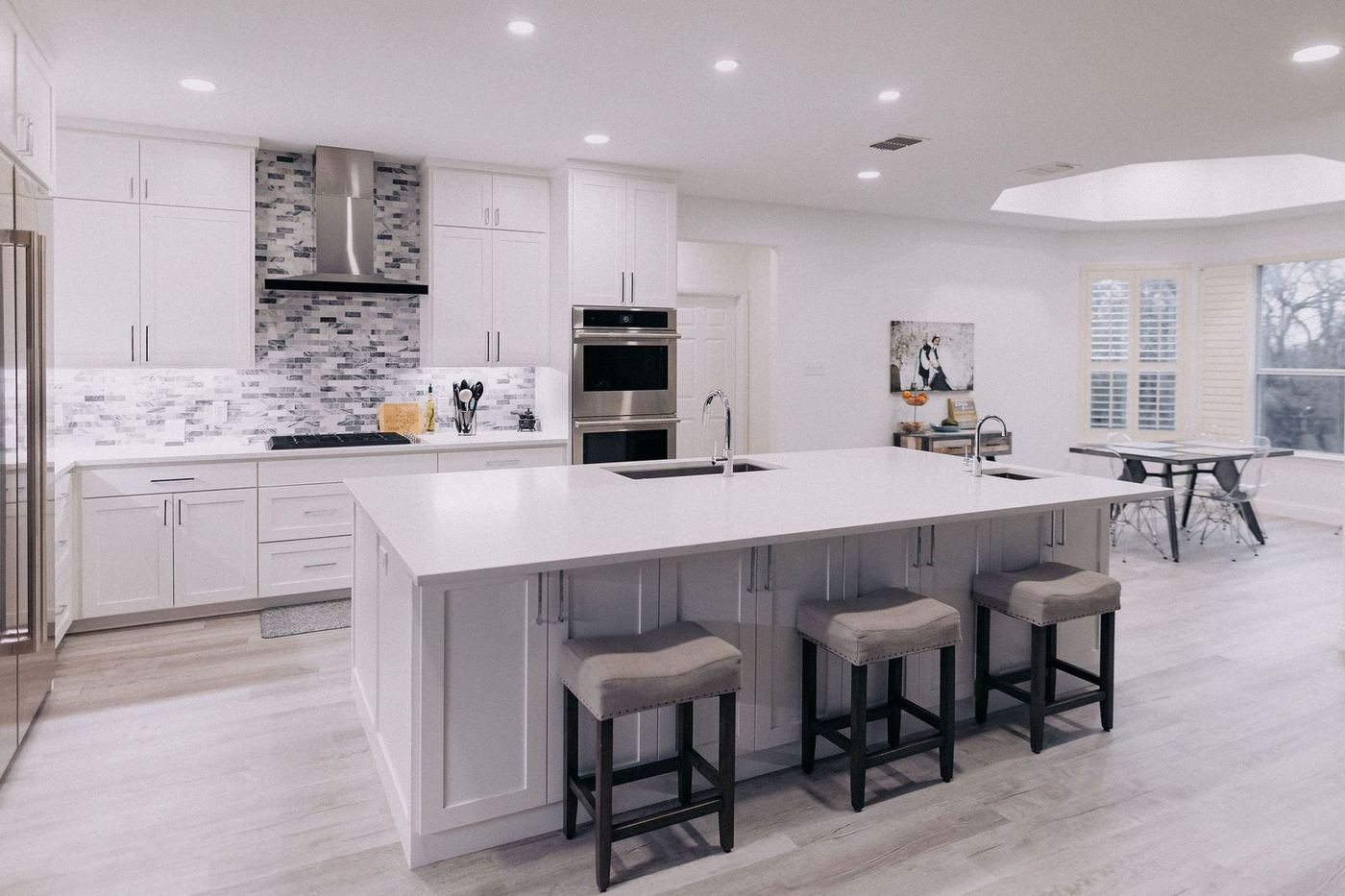 Remodeled white kitchen with quartz island and custom cabinetry in North Texas