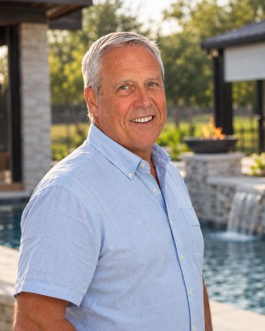 Glen Harrison, pool division lead at Harrison Building Co, beside a custom pool he built