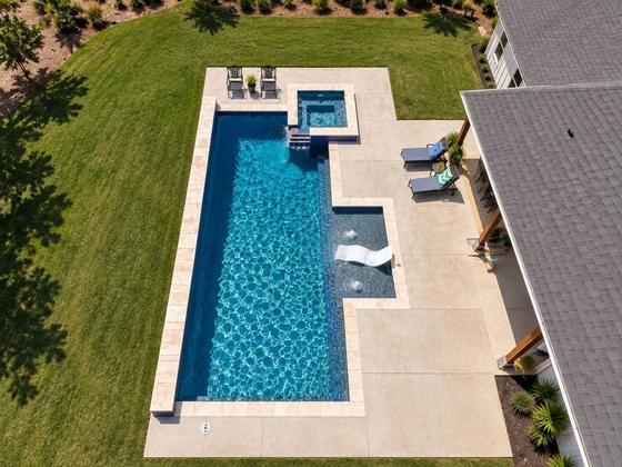 Aerial view of a custom lap pool with attached spa