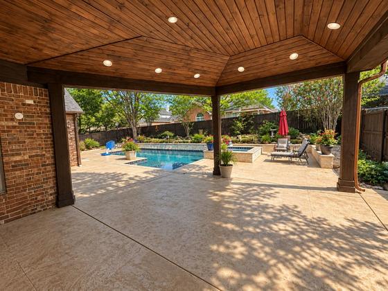 Covered patio looking out to a custom pool