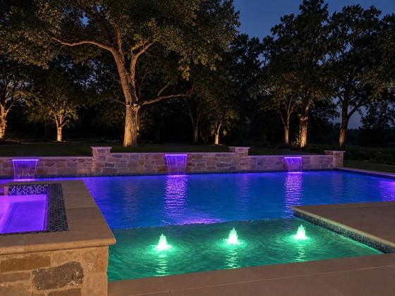 Custom pool and spa with color lighting at dusk