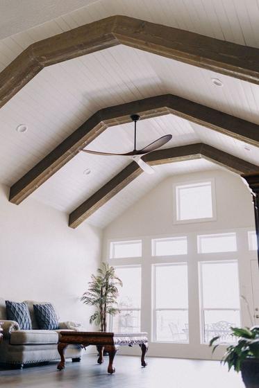 Great room with vaulted ceiling and stained timber trusses