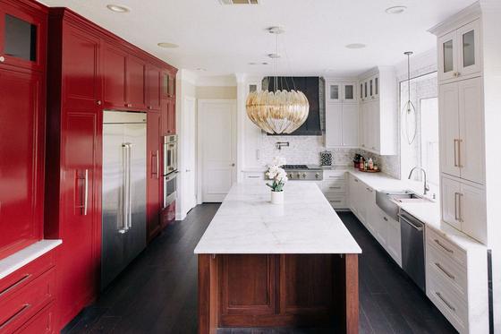 Kitchen remodel with lacquered red cabinetry and marble island